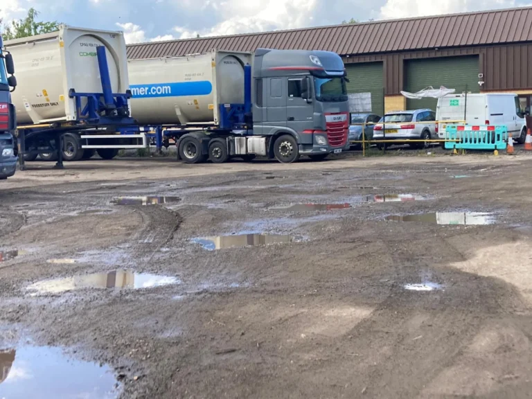 HGV trucks parked at a logistics yard with site security monitoring