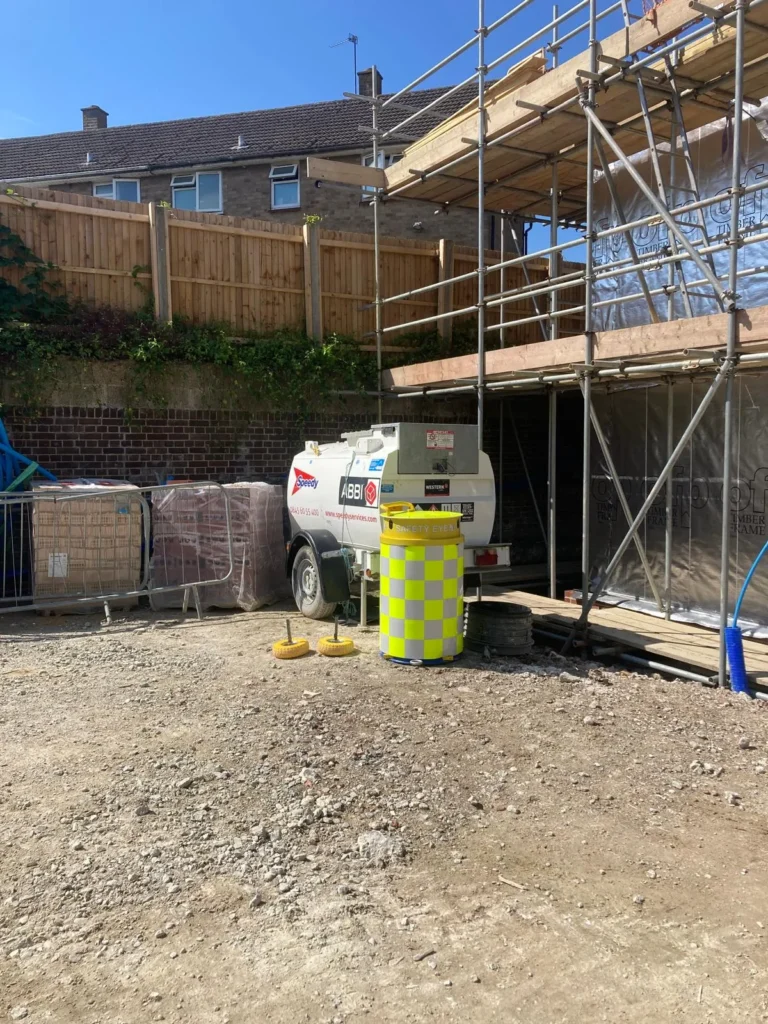 Safety Eye CCTV bollard on new build construction site with scaffolding and fuel tank